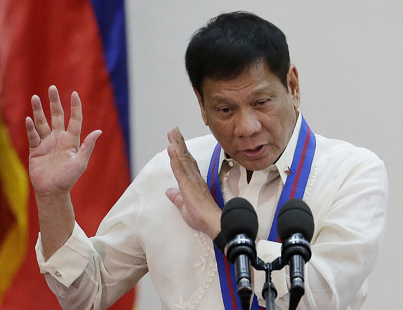 
              FILE - In this  July 1, 2016, file photo, Philippine President Rodrigo Duterte gestures during the "Assumption of Command" of new Police Chief, Director General Ronald Dela Rosa at Camp Crame, Philippine National Police headquarters, in suburban Quezon city, Philippines. Duterte publicly linked more than 150 judges, mayors, lawmakers, police and military personnel to illegal drugs Sunday, Aug. 7, 2016, ordering them to surrender for investigation as he ratcheted up his bloody war against what he calls a "pandemic." Duterte promptly relieved members of the military and police he named from their current posts and ordered government security personnel to be withdrawn from politicians he identified in a nationally televised speech. (AP Photo/Aaron Favila, File)
            