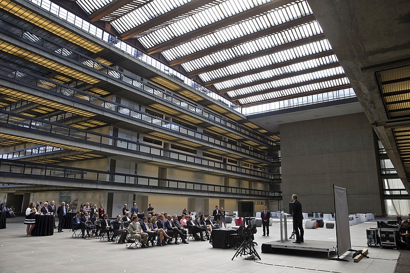 
              In this Wednesday, July 20, 2016 photo, a group gathers inside the long vacant former Bell Labs building in Holmdel, N.J. The 2 million-square-foot building where Bell Labs scientists helped launch modern cellular networks before it became one of the country's largest vacant office buildings is drawing companies with the lure of working at a complex surrounded by technological history. (Doug Hood/The Asbury Park Press via AP)
            