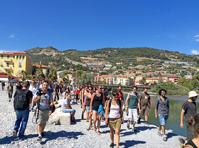 
              A No Borders group of activists walk along the seaside during a spontaneous march in Ventimiglia, Italy, Sunday, Aug. 7, 2016, after calling off an unauthorized protest as Italian border police detained three people trying to cross into Italy from France armed with clubs, knives, a hatchet, a wrench and hoods. (Fabrizio Tenerelli/ANSA via AP Photo)
            