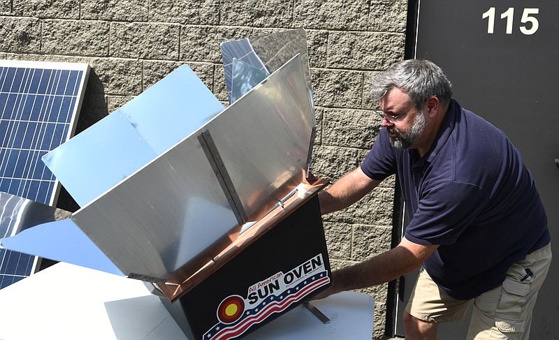 Duke Cumbelich levels a solar oven outside of his business, P5 Preparedness in East Brainerd.