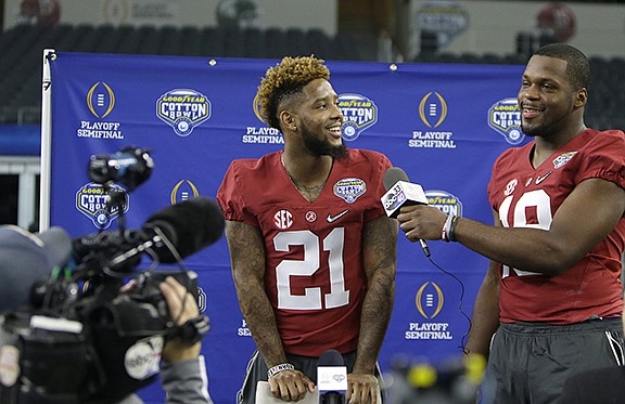 Alabama defensive back Maurice Smith (21) is playfully interviewed by teammate linebacker Reggie Ragland (19) during the media day for the NCAA Cotton Bowl college football game Tuesday, Dec. 29, 2015, in Arlington, Texas. (AP Photo/LM Otero)