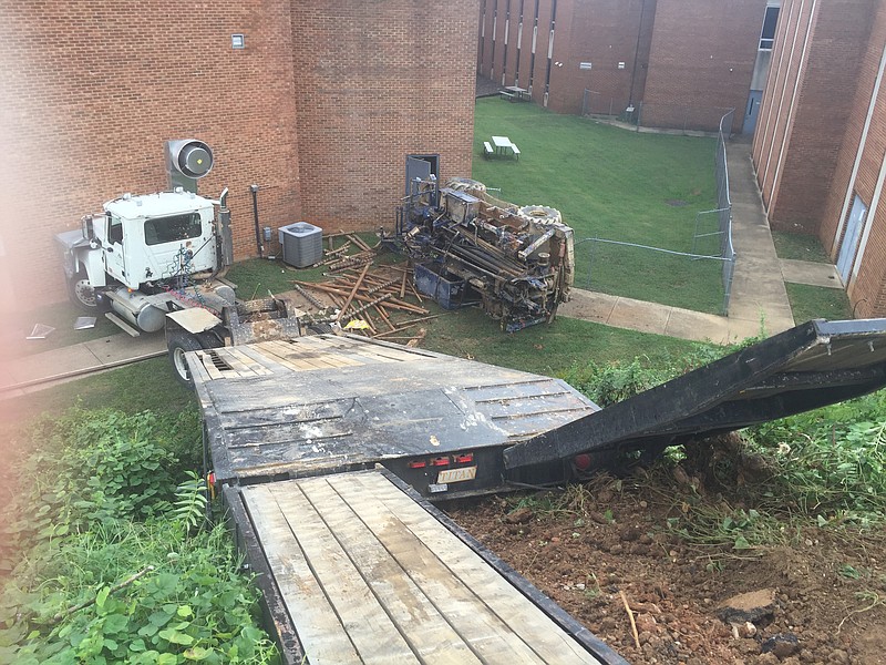 Police are waiting for a second wrecker to arrive so that a truck can be towed after it ran down a hill into First Baptist Church of Chattanooga.
