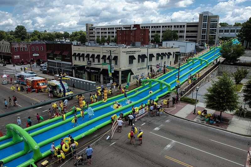 This overview of last year's Slide the City shows how the three-block-long water slide fills Fifth Street.
