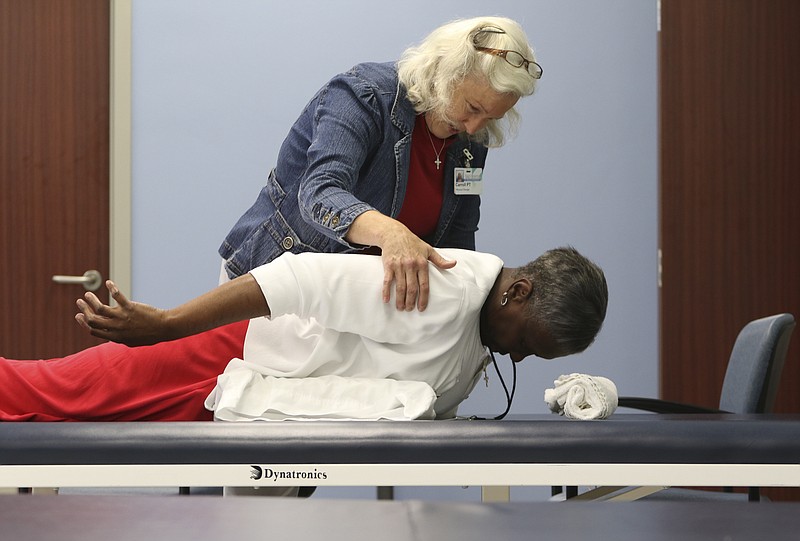 Staff Photo by Dan Henry / The Chattanooga Times Free Press- 8/9/16. Carroll Allen works with Thelma Webster to perform exercises to help her limit the effects of osteoporosis while at Siskin Hospital's outpatient ortho gym on Tuesday, August 9, 2016.