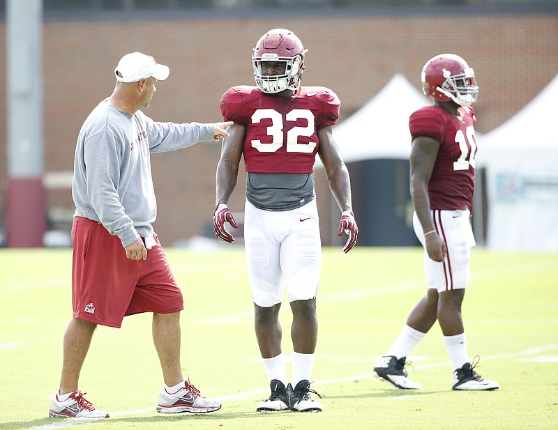 Alabama first-year defensive coordinator Jeremy Pruitt works with linebacker Rashaan Evans during Tuesday's practice in Tuscaloosa.