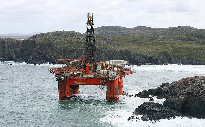 
              The Transocean Winner drilling rig is seen off the coast of the Isle of Lewis, Scotland, after it ran aground in severe weather conditions, Tuesday Aug. 9, 2016.  The oil rig, carrying 280 tonnes of diesel, broke free of its tug and ran aground on the remote Scottish beach where it is being monitored by a counter-pollution team.  (Andrew Milligan / PA via AP)
            