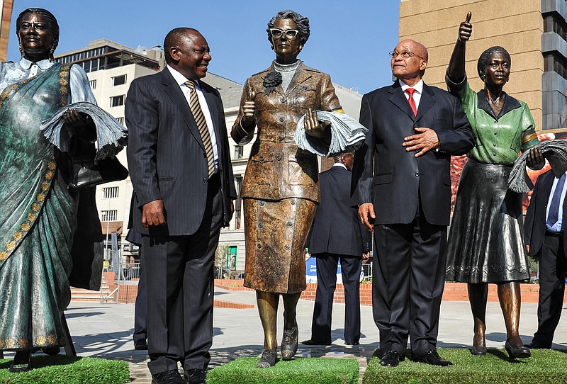 
              Deputy President Cyril Ramaphosa, left, and President Jacob Zuma, right, stand among recently unveiled statues of women who took part in a 1956 protest march to Pretoria, during Women's Day celebrations in Pretoria, South Africa, Tuesday Aug. 9, 2016. In speaking during celebrations Zuma avoided making any reference to an anti-rape protest against him on live television days earlier.  (AP Photo)
            