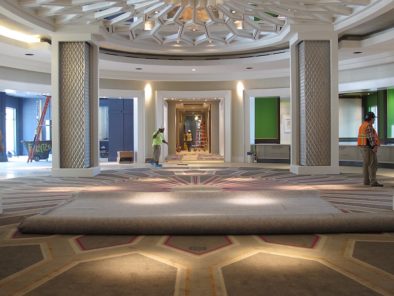 
              In this Aug. 8, 2016 photo, workers are seen in the circular lobby area of the new 450-room Guest House at Graceland in Memphis, Tenn. Elvis Presley used to dream about building a guest house at his Graceland property, for friends who would visit the rock and roll icon in Memphis. Presley didn't get to see his dream come true, but his fans will. The Guest House at Graceland is being built just steps from Presley's former home, and it aims to impress Memphis visitors with modern design and amenities with an exterior evocative of a comfortable Southern Colonial home. It is set to open Oct. 27. (AP Photo/Adrian Sainz)
            