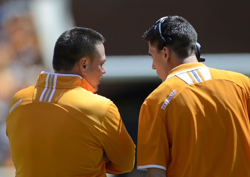UT coach Butch Jones, left, talks with Chris Spognardi during the 2013 Orange and White game Saturday at Neyland Stadium.