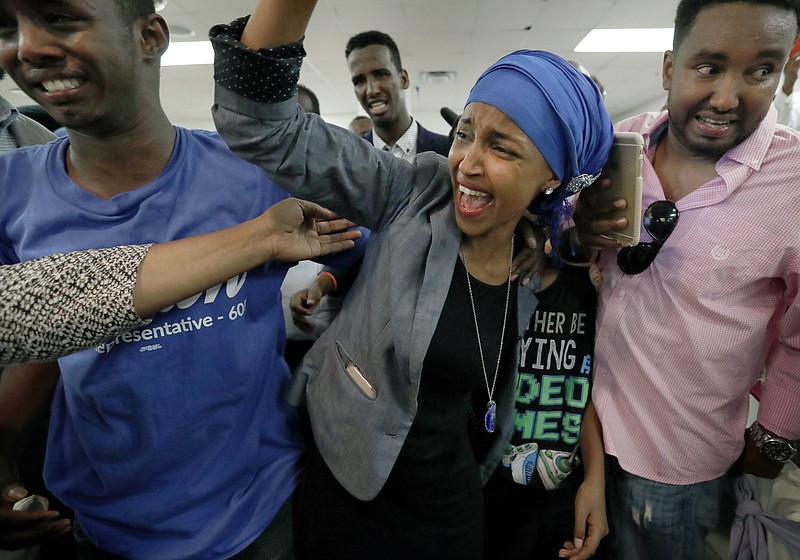 
              Somali activist Ilhan Omar is greeted by supporters at Kalsan Tuesday, Aug. 9, 2016, in Minneapolis. Omar defeated 22-term Rep. Phyllis Kahn in Tuesday's nominating contest in the heavily Democratic Minneapolis district. (Carlos Gonzalez/Star Tribune via AP)
            