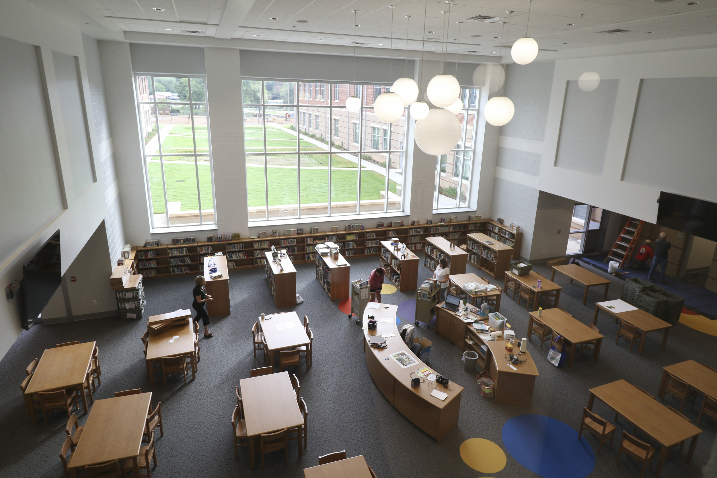 Staff Photo by Dan Henry / The Chattanooga Times Free Press- 8/9/16. Middle Valley Elementary School teachers and volunteers work to fill the media center at the new school on Tuesday, August 9, 2016.