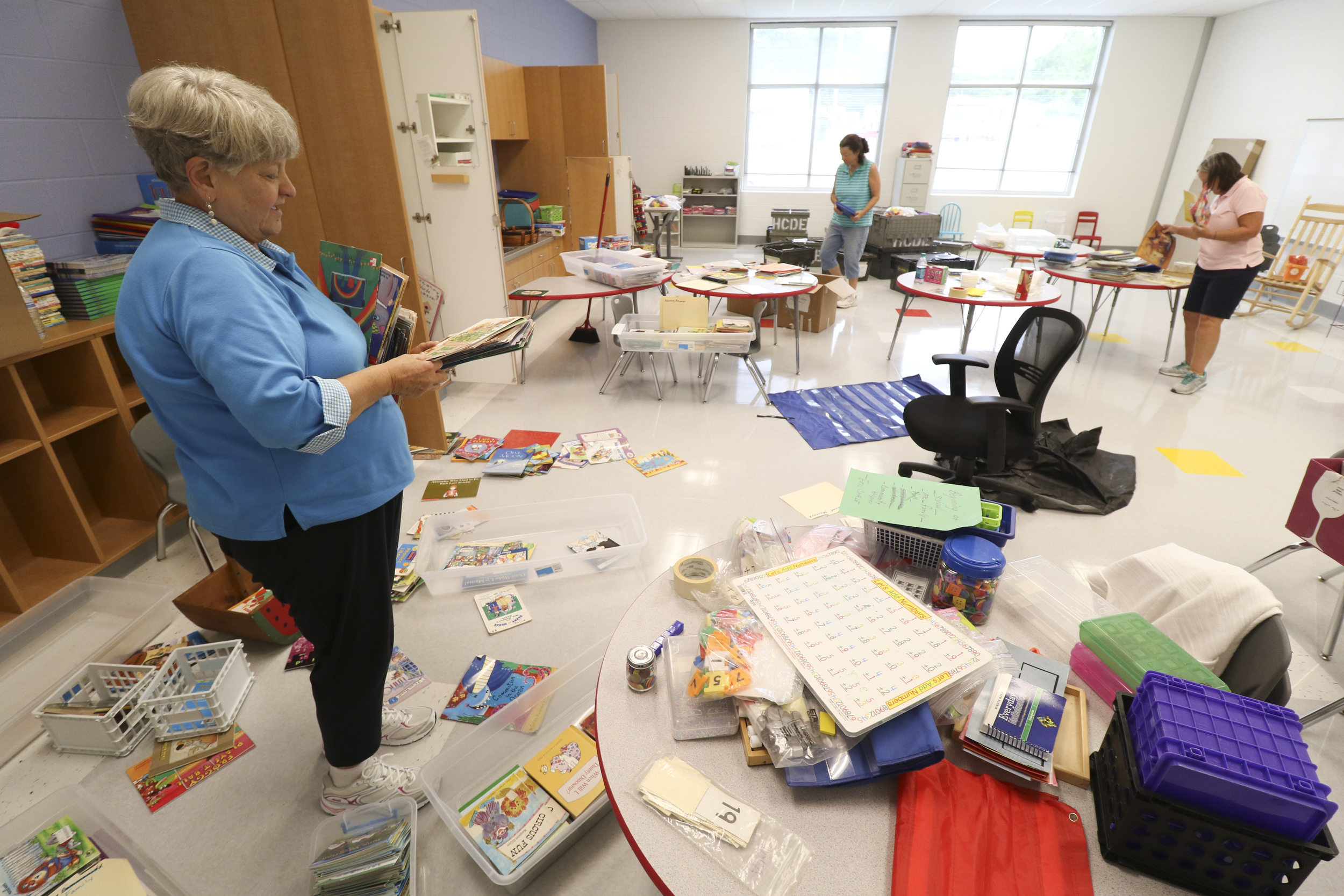 Staff Photo by Dan Henry / The Chattanooga Times Free Press- 8/9/16. Susie Low, left, works with Mary Agnes Noonan and Margaret Alley to set up Alley's kindergarten classroom at the new Middle Valley Elementary School on Tuesday, August 9, 2016.