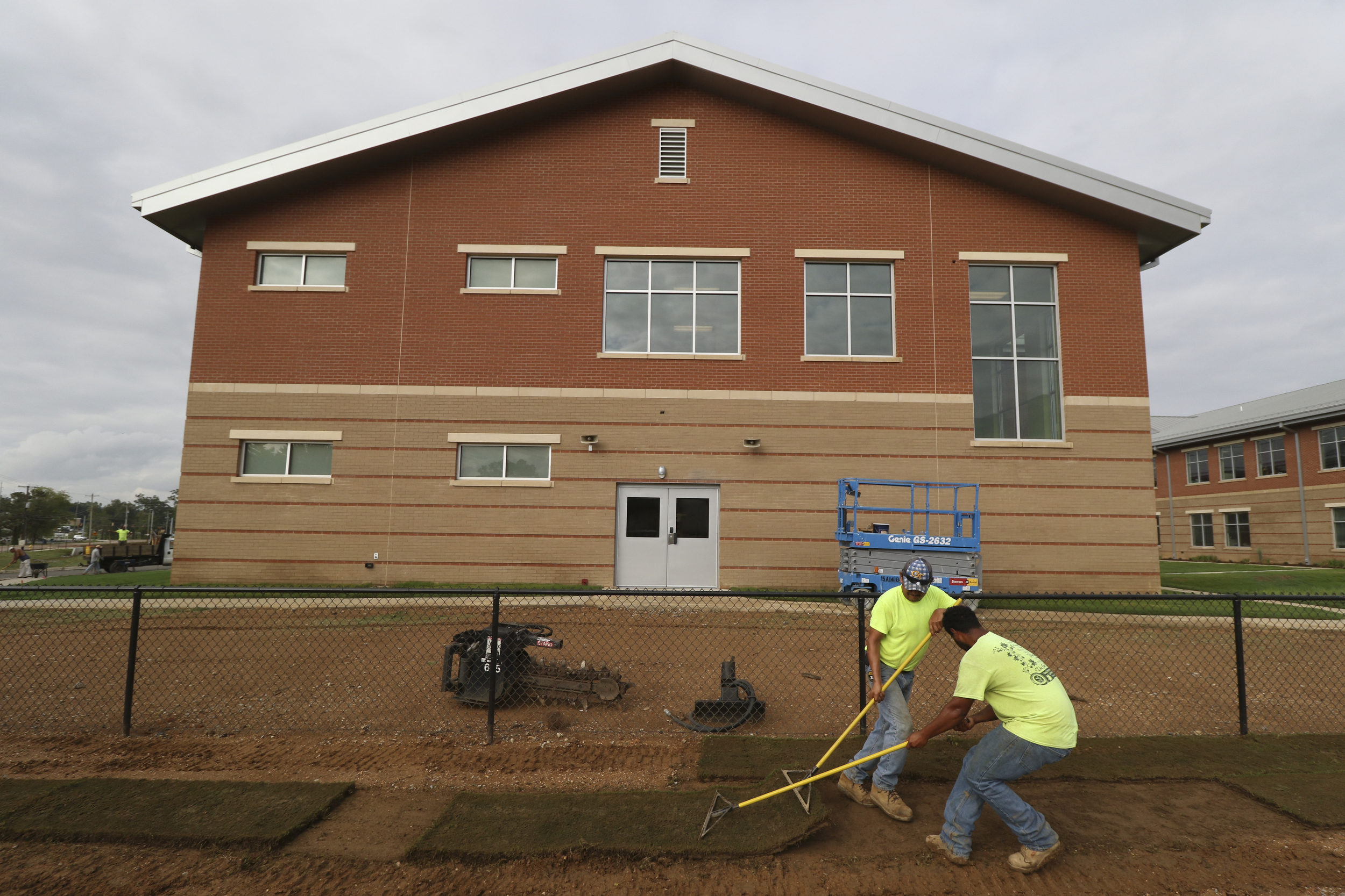 Staff Photo by Dan Henry / The Chattanooga Times Free Press- 8/9/16. Angel Santiago, close, and Morendo Santos lay sod at the new Middle Valley Elementary School on Tuesday, August 9, 2016.