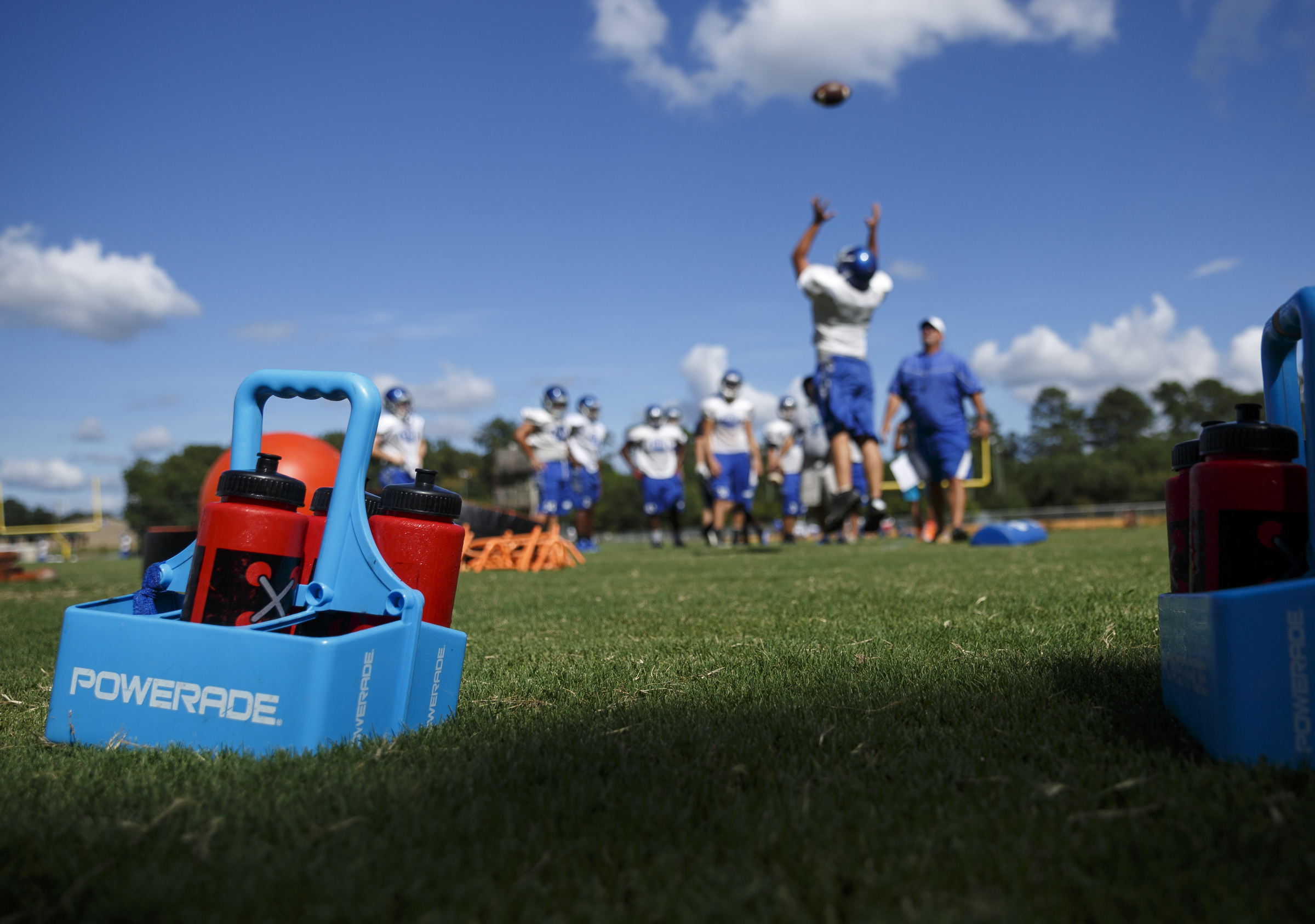 Water bottles are kept nearby during football practice at Gordon Central High School on Wednesday, Aug. 10, 2016, in Calhoun, Ga.