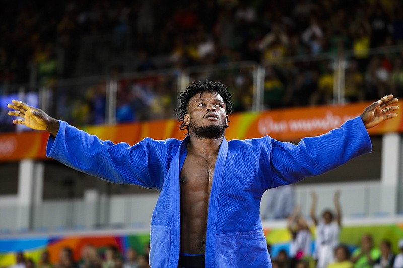 
              Popole Misenga, who competes for the Refugee Olympic Team, reacts after winning his first match against India's Avtar Singh during the men's 90-kg judo competition at the 2016 Summer Olympics in Rio de Janeiro, Brazil, Wednesday, Aug. 10, 2016. (AP Photo/Markus Schreiber)
            
