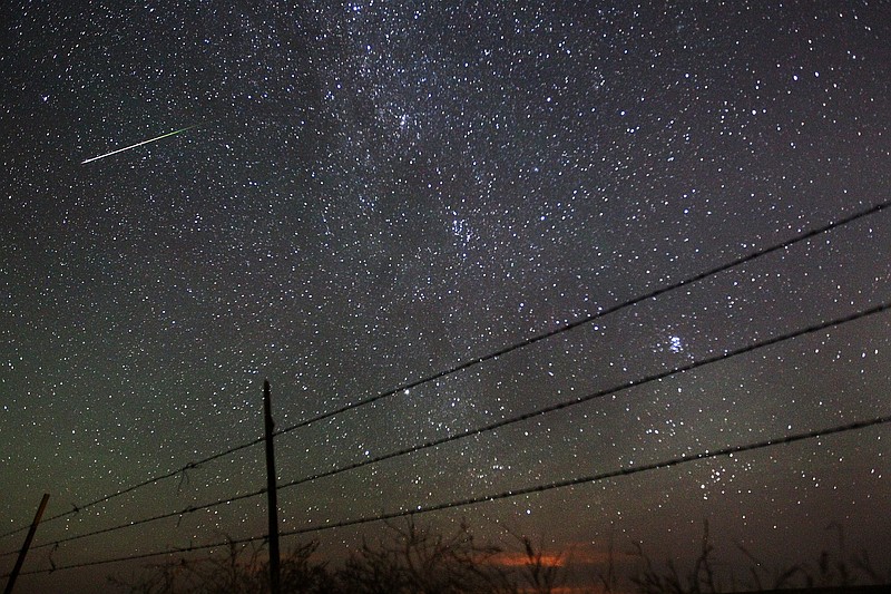 
              FILE - In this early morning, Aug. 13, 2013 file photo, a meteor streaks past the faint band of the Milky Way galaxy above the Wyoming countryside north of Cheyenne, Wyo., during a Perseids meteor shower. On Thursday night, Aug. 11, 2016 into early Friday morning, the Perseid meteor shower is expected to peak with double the normal number of meteors. Scientists call this an outburst, and they say it could reach up to 200 meteors per hour. (AP Photo/The Wyoming Tribune Eagle, Blaine McCartney)
            