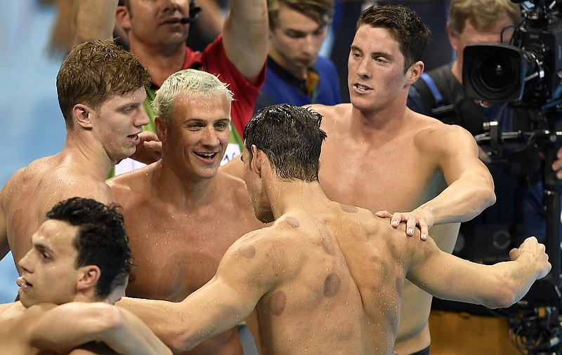 United States' Townley Haas, Ryan Lochte, Conor Dwyer, and Michael Phelps, from left clockwise, celebrate after winning the gold medal in the men's 4x200-meter freestyle final during the swimming competitions at the 2016 Summer Olympics, Tuesday, Aug. 9, 2016, in Rio de Janeiro, Brazil.