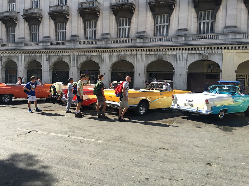 McCallie students get ready for a sightseeing tour of Havana in vintage convertibles. After the 1960 U.S. embargo against Cuba, American cars were almost impossible to buy, so Cubans had to take care of their 1950s cars, passing them down generations.