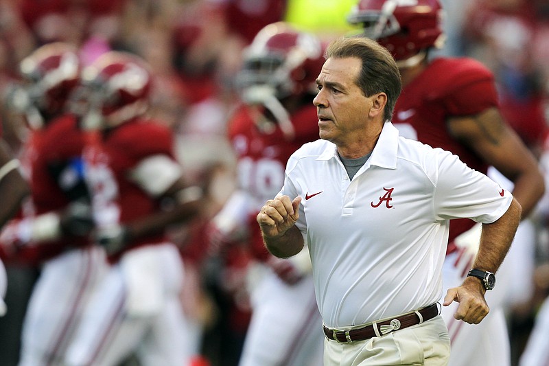 In this Oct. 19, 2013, file photo, Alabama head coach Nick Saban runs onto the field before the first half of an NCAA college football game against Arkansas in Tuscaloosa, Ala. (AP Photo/Butch Dill, File)