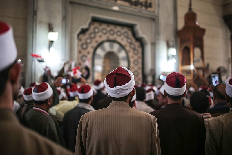 
              FILE - In this Feb. 3, 2015 file photo, Egyptian clerics from Al-Azhar institution rally to denounce terrorism and show solidarity with the Egyptian government and security forces at a mosque in central, Cairo, Egypt. In July 2016 the Egyptian government launched a radical bid to establish control over Egypt’s religious discourse, mandating that all imams at all mosques across the country read pre-written sermons distributed by the ministry. The government describes the initiative, unprecedented in Egypt’s history, as a means of weeding out extremist ideology, but it has proved extremely unpopular, with critics accusing the state of stifling the freedom of thought and creativity of the clerics. (AP Photo/Mosa'ab Elshamy, File)
            