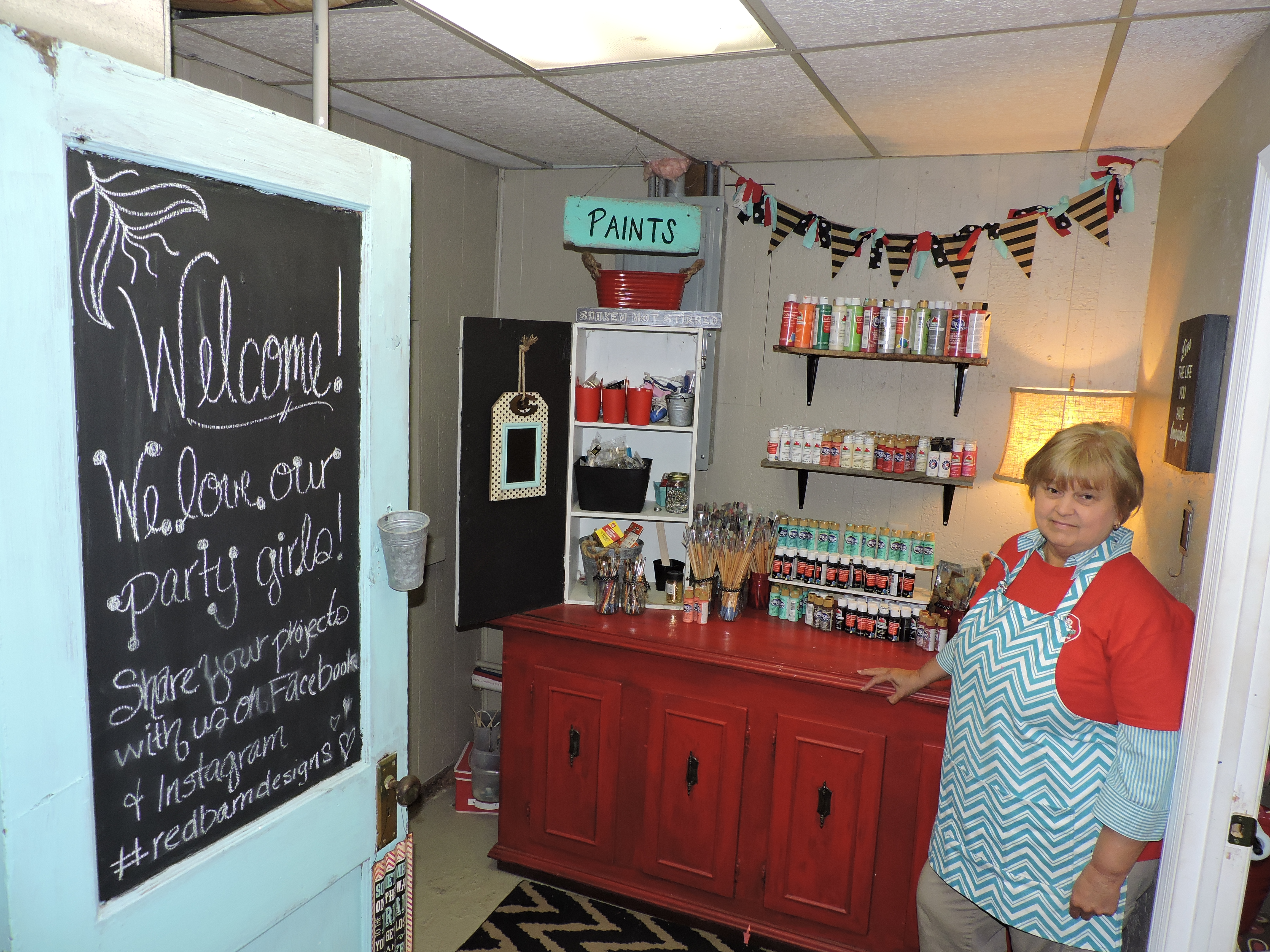 Red Barn Designs co-owner Mary Hartman showcases the room where ladies pick out their colors to paint with at the store.