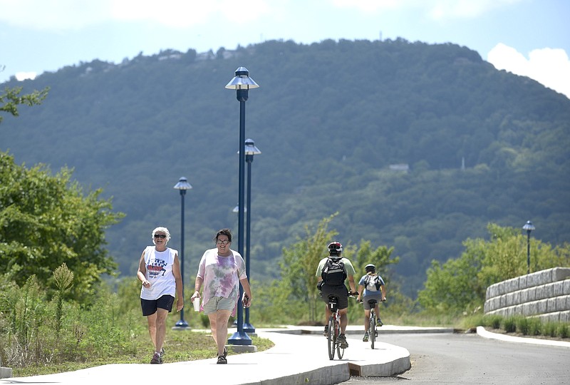 Beth Knoll, left, and Shari Pilgrim walk on the newly-opened section of the Riverwalk near the former U.S. Pipe facility Friday, August 12, 2016.