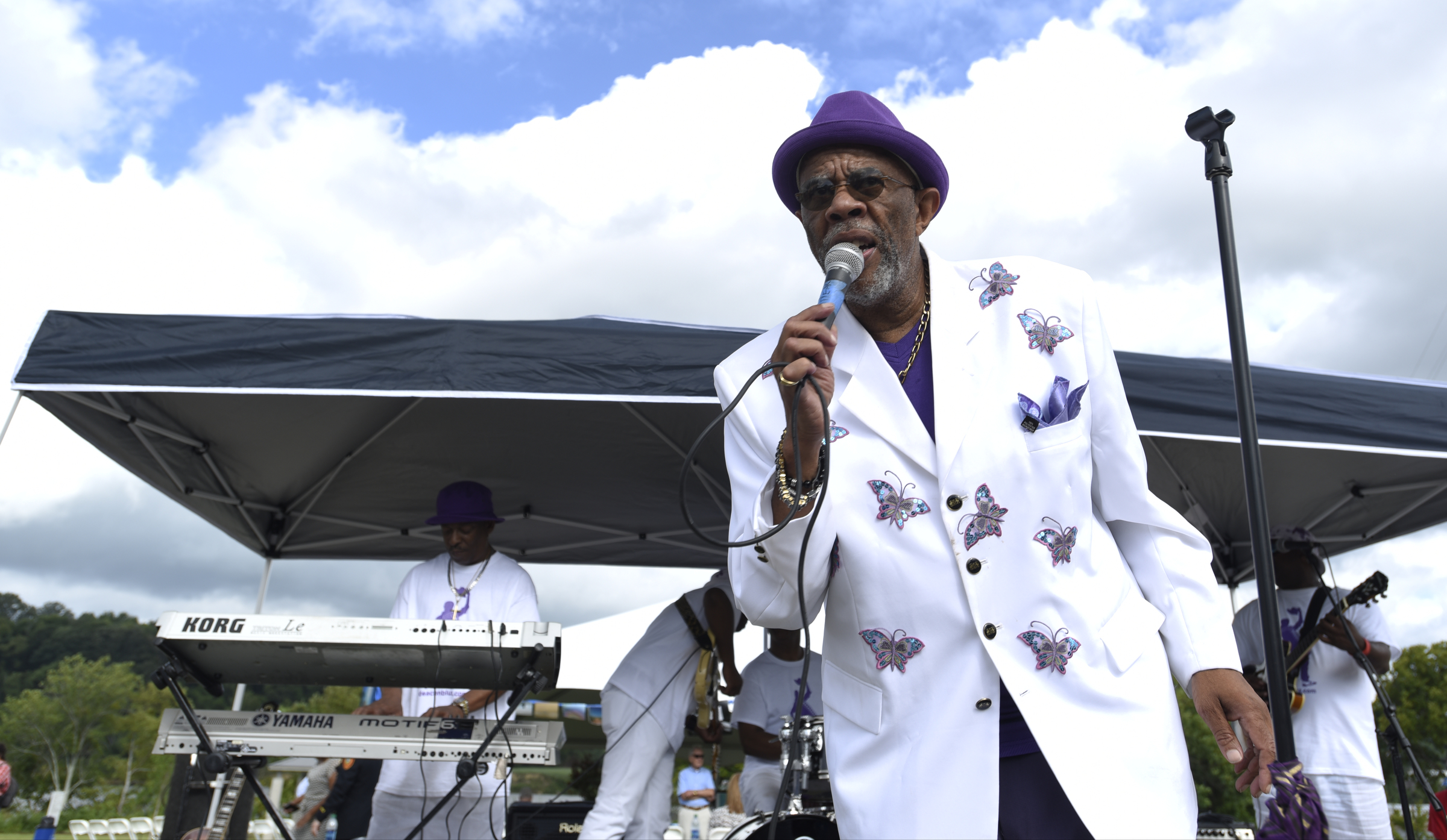 Dr. Clark White sings with Deaconbluz and the River City All Stars during the grand opening of the 3-mile extension of the Riverwalk Friday, August 12, 2016.