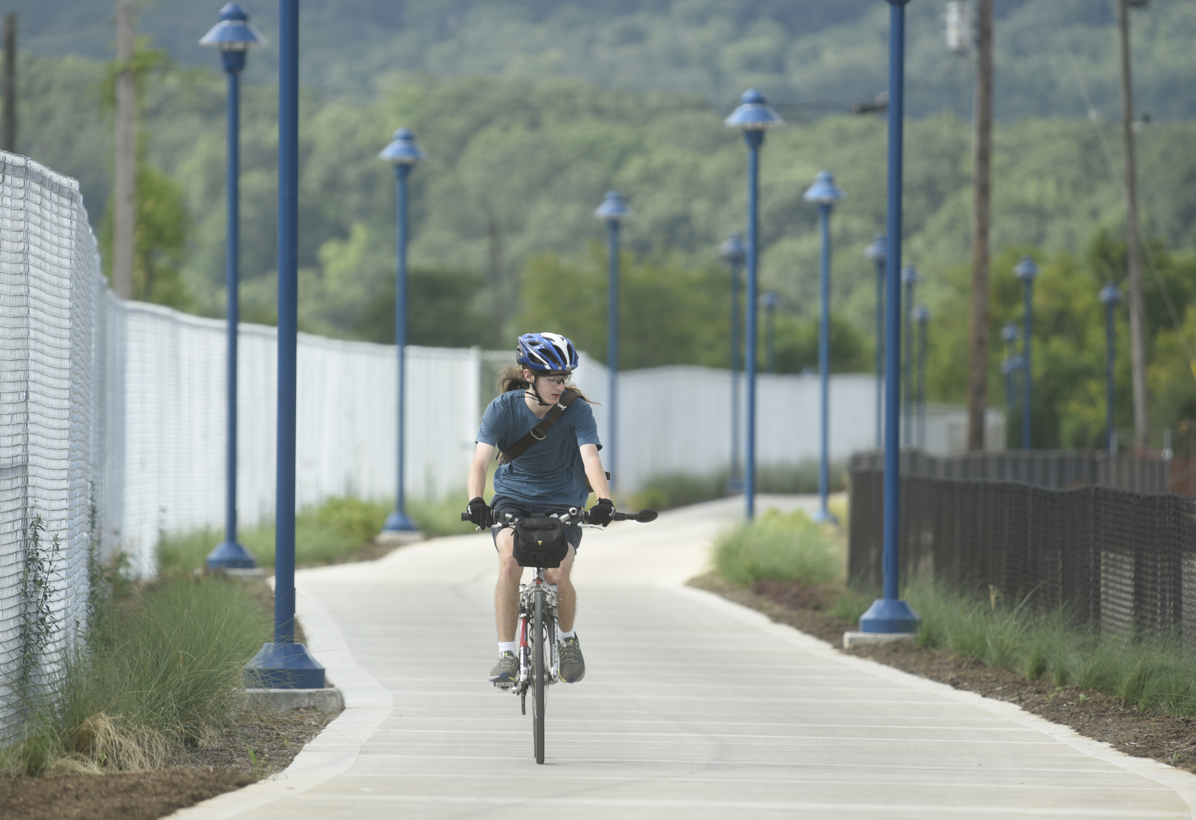 Zachary Cross rides his bike from St. Elmo to the grand opening of the 3-mile extension of the Riverwalk Friday, August 12, 2016.