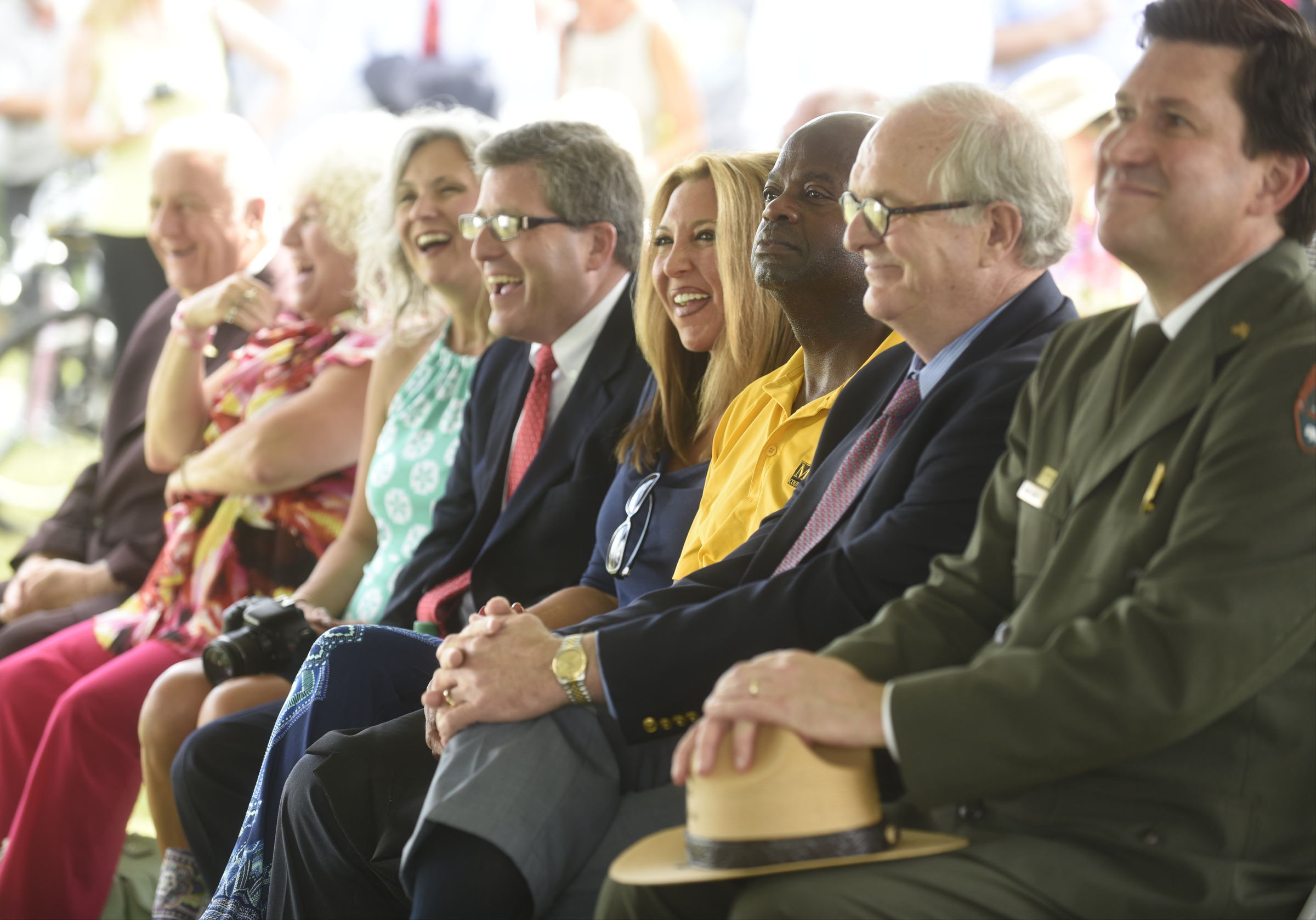 Elected officials and others listen during grand opening of the 3-mile extension of the Riverwalk Friday, August 12, 2016.