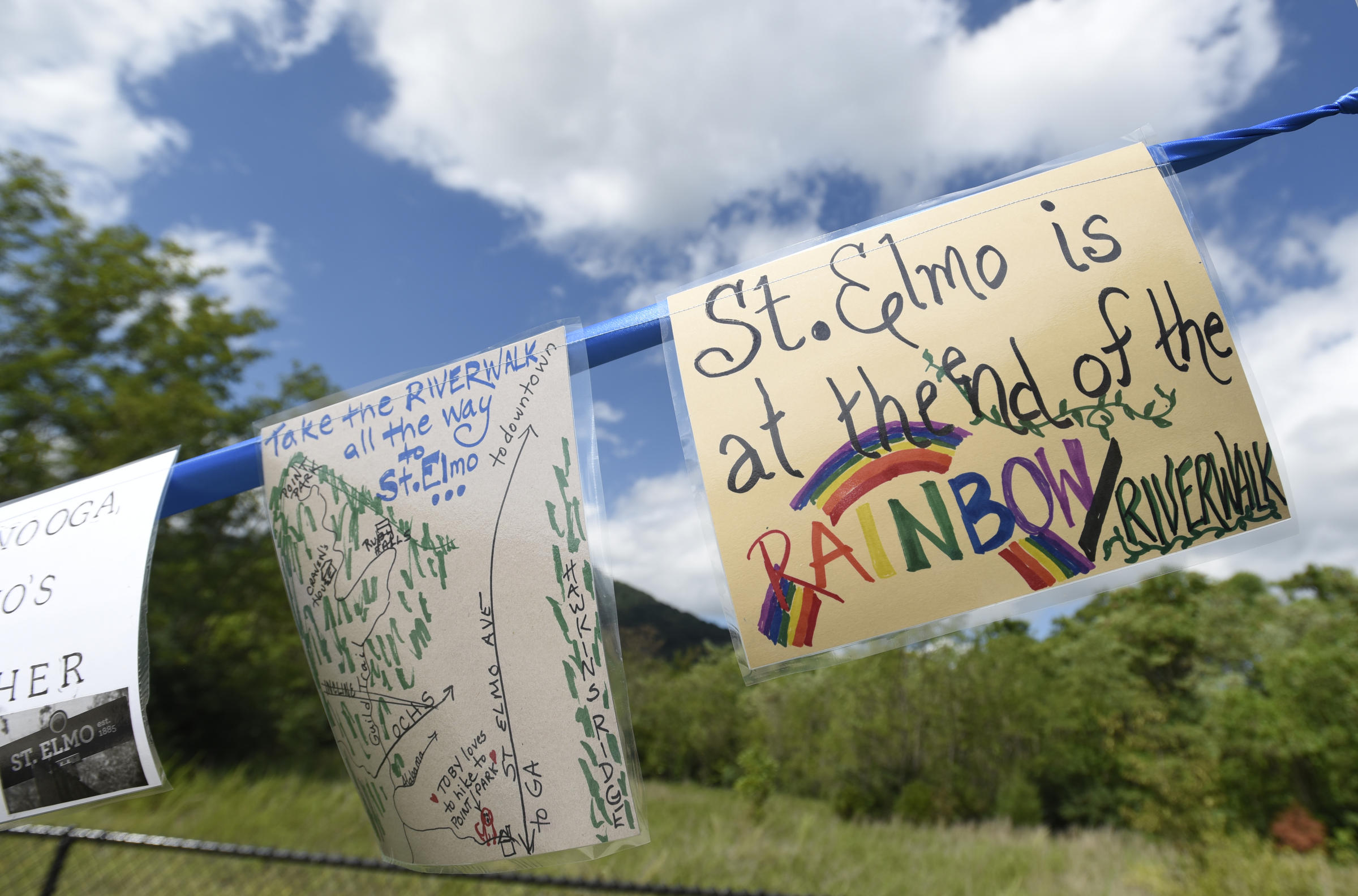 Signs hang at the end of the newly-opened section of the Riverwalk Friday, August 12, 2016.