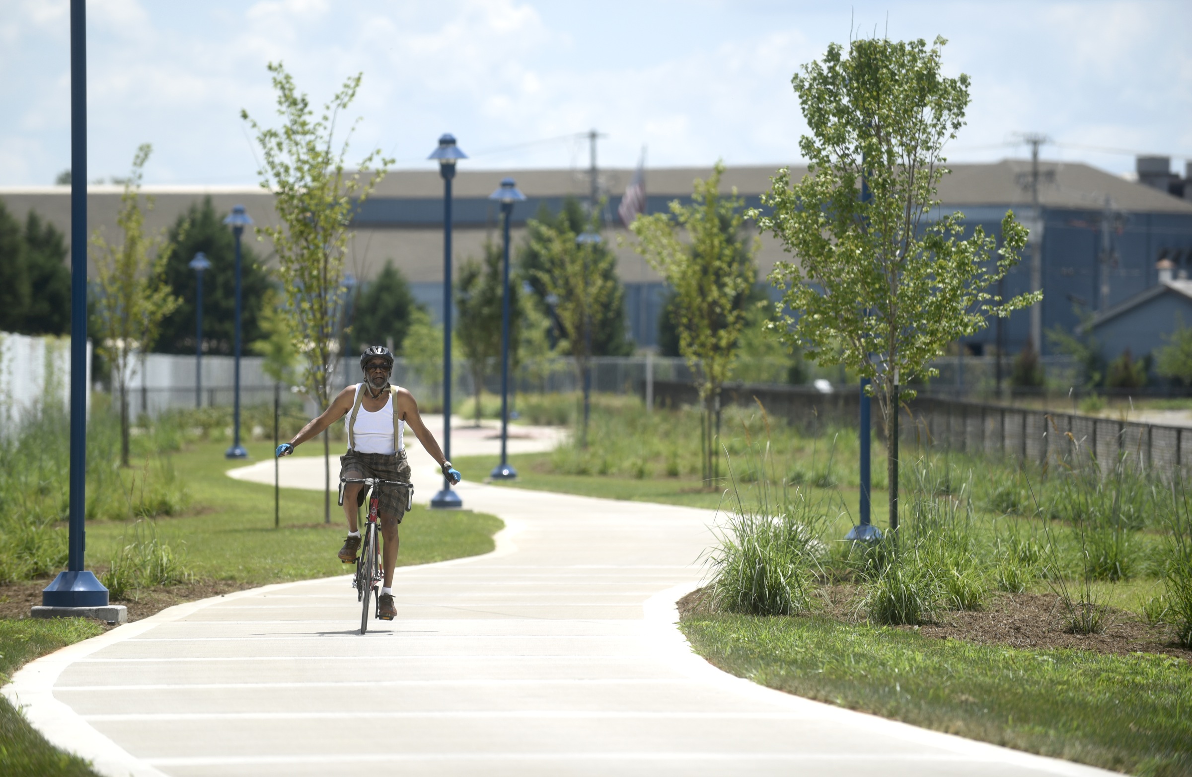 A cyclists travels on the newly-opened section of the Riverwalk Friday, August 12, 2016.