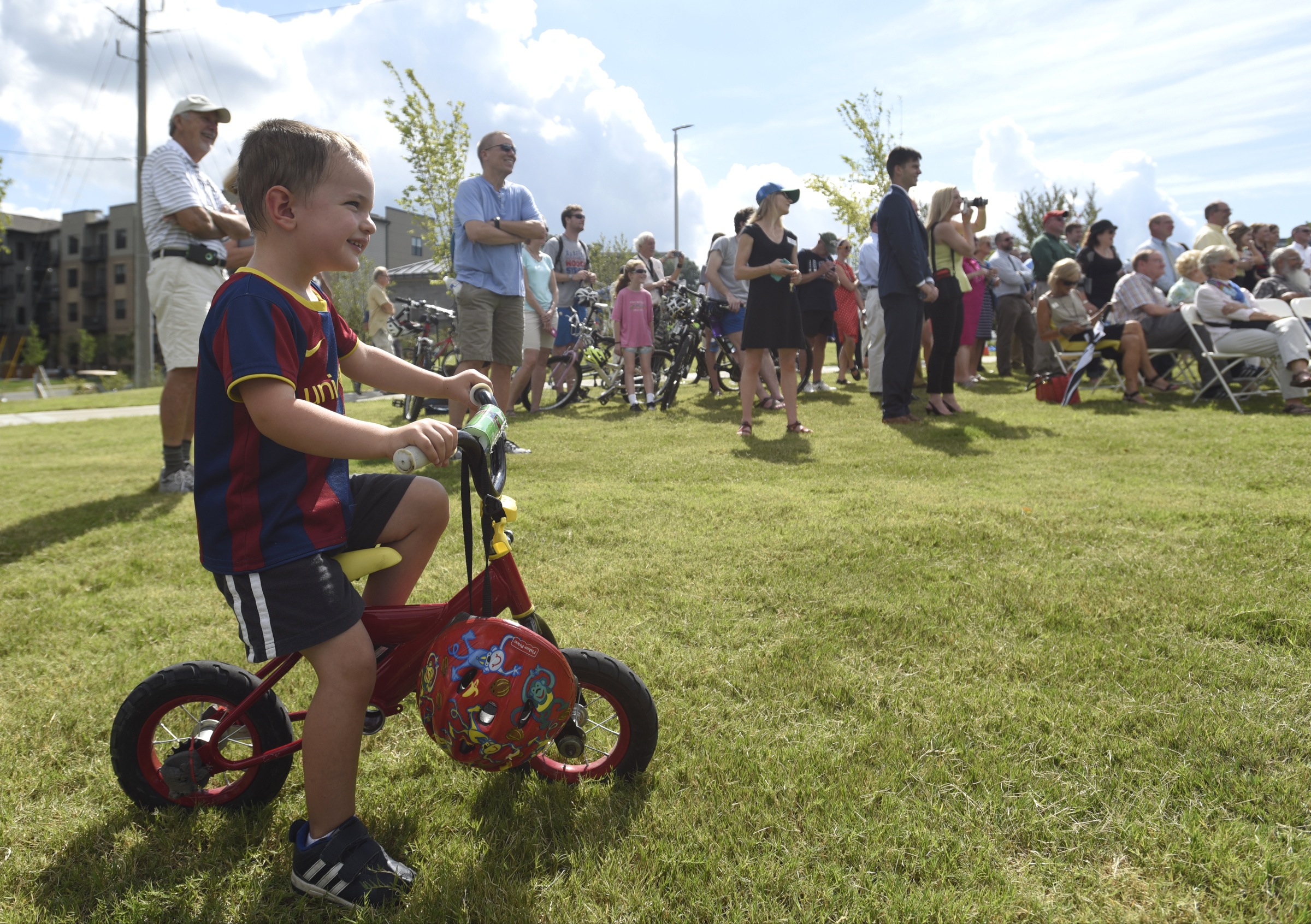 Three-year-old Isaac Sweets watches the grand opening ceremony of the 3-mile extension of the Riverwalk Friday, August 12, 2016.