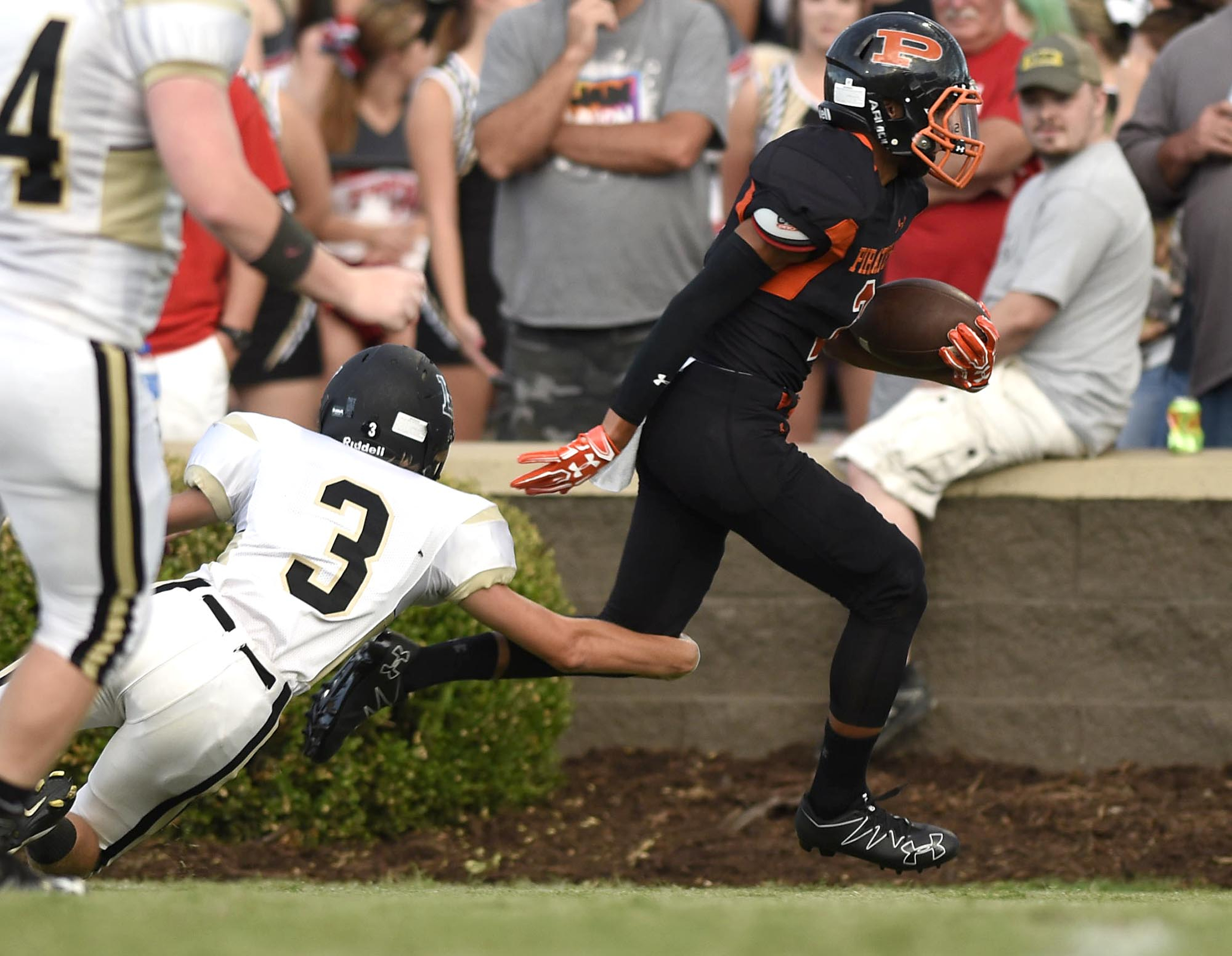South Pittsburg's Lajuan Ford (2) breaks the tackle of Lookout Valley's Josh Ibach (3) as he goes for a Pirate touchdown. The Sequatchie Valley Football Jamboree was held at South Pittsburg High School on Friday August, 12, 2016.