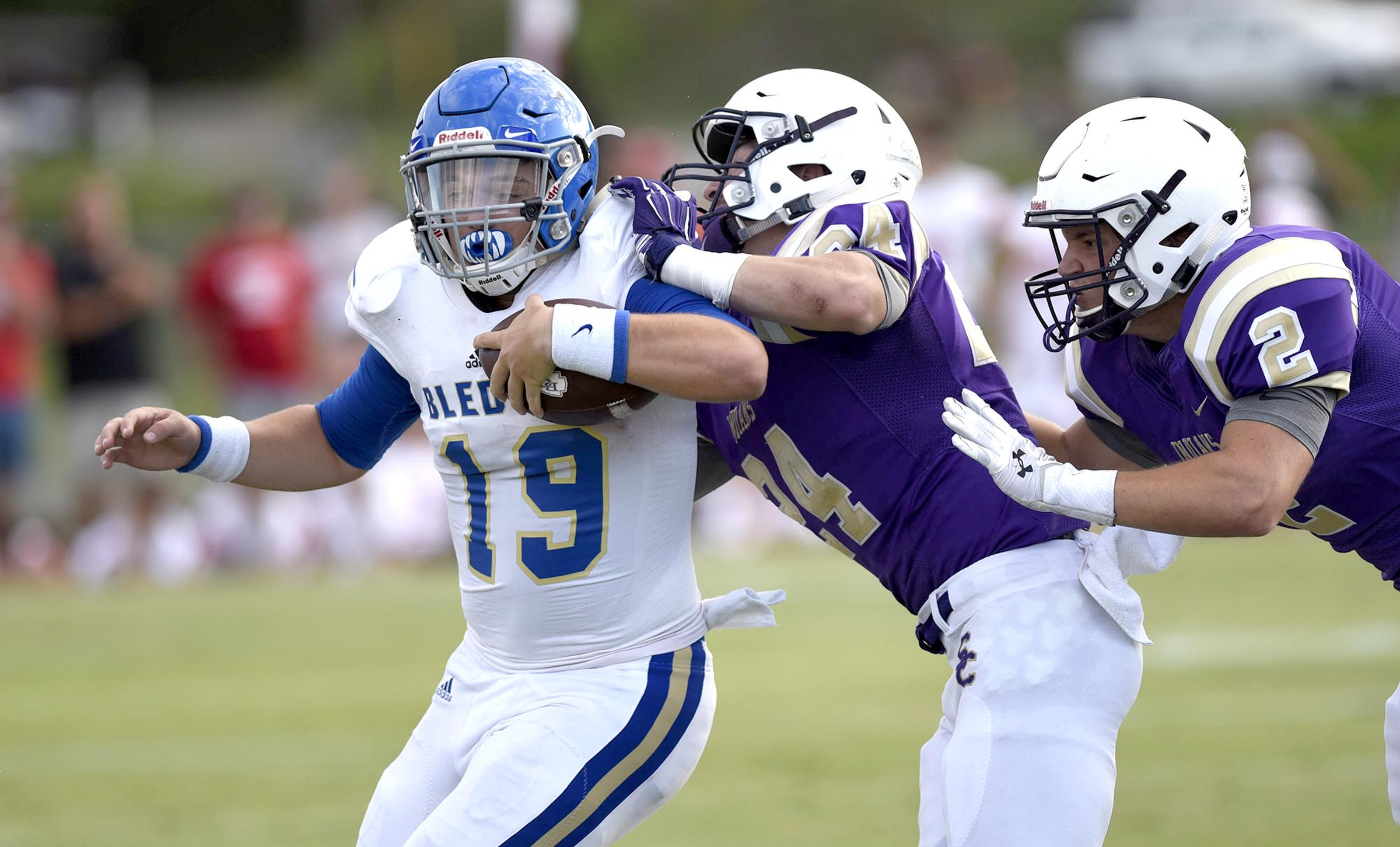 Bledsoe County quarterback Chaise Sorrow (19) is pushed out-of-bounds by Sequatchie's Austin Stephens (24) and Kyle Cates (2). The Sequatchie Valley Football Jamboree was held at South Pittsburg High School on Friday August, 12, 2016.