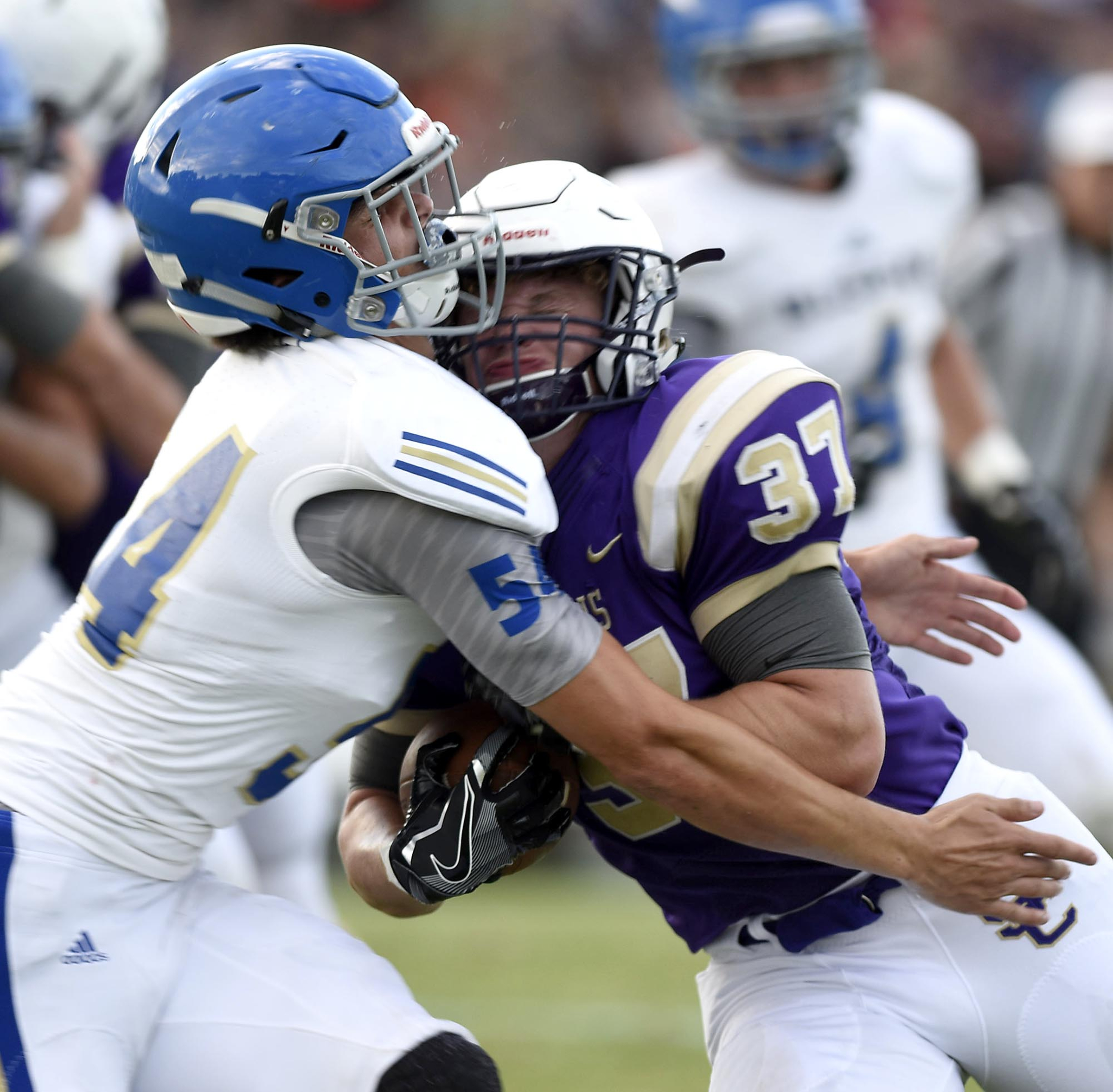 Bledsoe County defender Derrick Pursley (54) collides with Sequatchie's Hunter Davenport (37) has he makes the tackle. The Sequatchie Valley Football Jamboree was held at South Pittsburg High School on Friday August, 12, 2016.