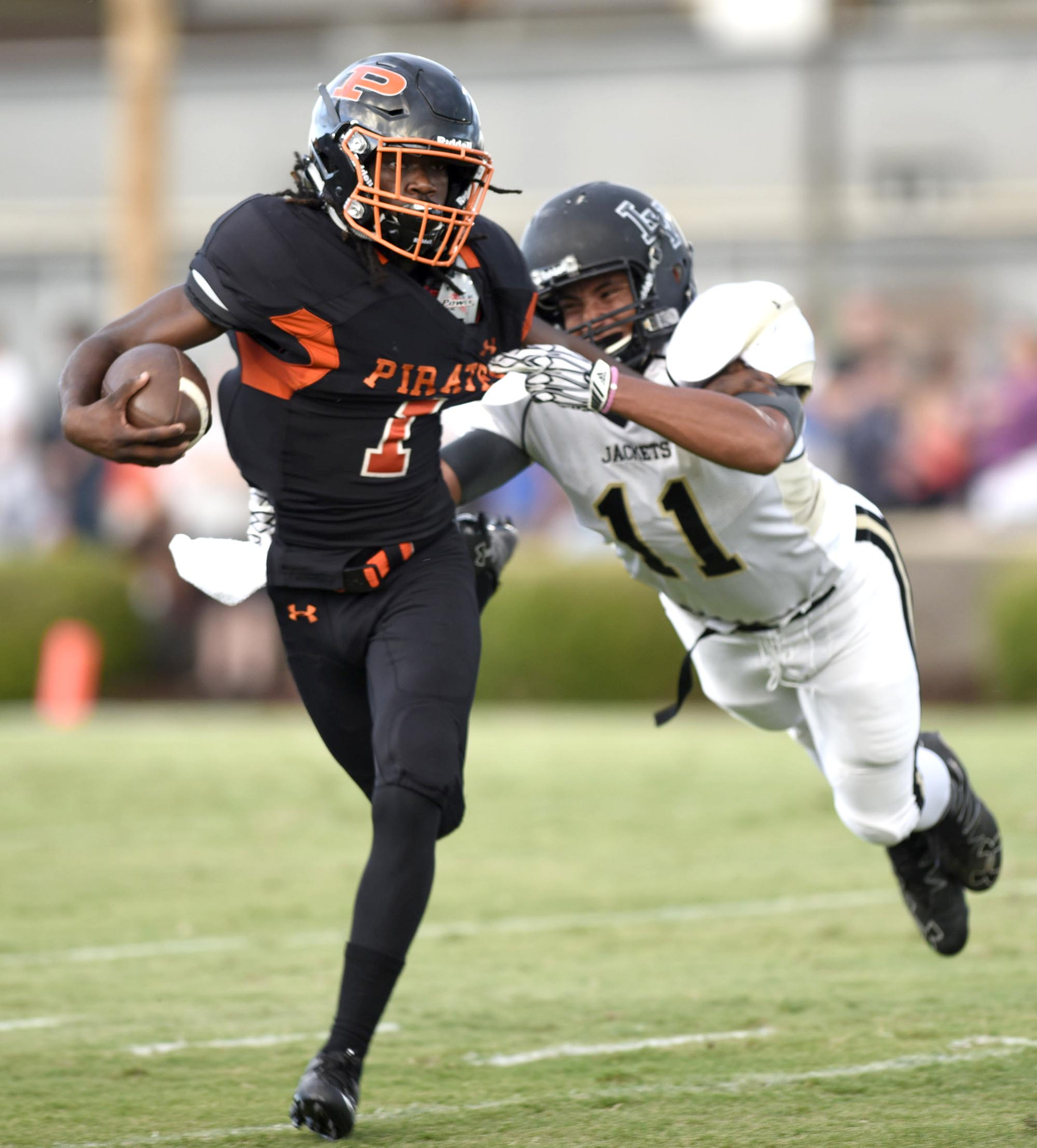 South Pittsburg's Kyree Pryor breaks past the attempted tackle of Lookout Valley's Tyrece Ragland (11). The Sequatchie Valley Football Jamboree was held at South Pittsburg High School on Friday August, 12, 2016.