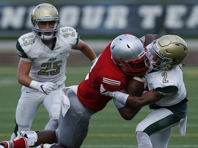 Baylor's Brendon Harris, center, is tackled by Notre Dame's Andrew Banks during their football game in the prep football jamboree at Finley Stadium on Saturday, Aug. 13, 2016, in Chattanooga, Tenn.