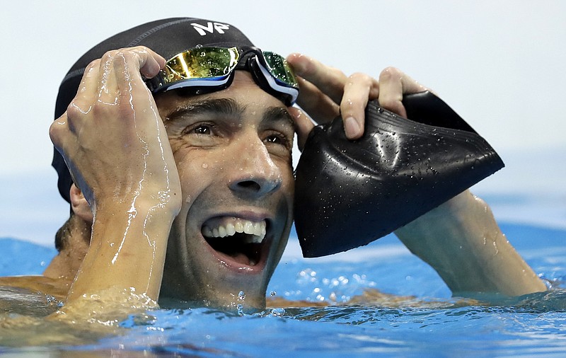 
              United States' Michael Phelps reacts after the men's 100-meter butterfly final during the swimming competitions at the 2016 Summer Olympics, Friday, Aug. 12, 2016, in Rio de Janeiro, Brazil. (AP Photo/Michael Sohn)
            