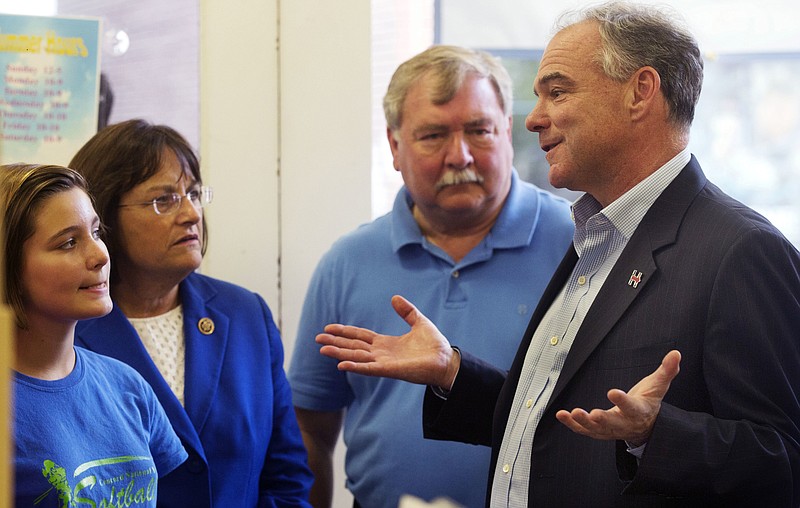 
              Democratic vice presidential candidate Sen. Tim Kaine, D-Va., right, talks with Charlotte Goble during a quick stop at Granite State Candy with Rep. Ann Kuster, D-N.H., and state Rep. Steve Shurtleff in Concord, N.H. Friday, Aug. 12, 2016. (AP Photo/Jim Cole)
            