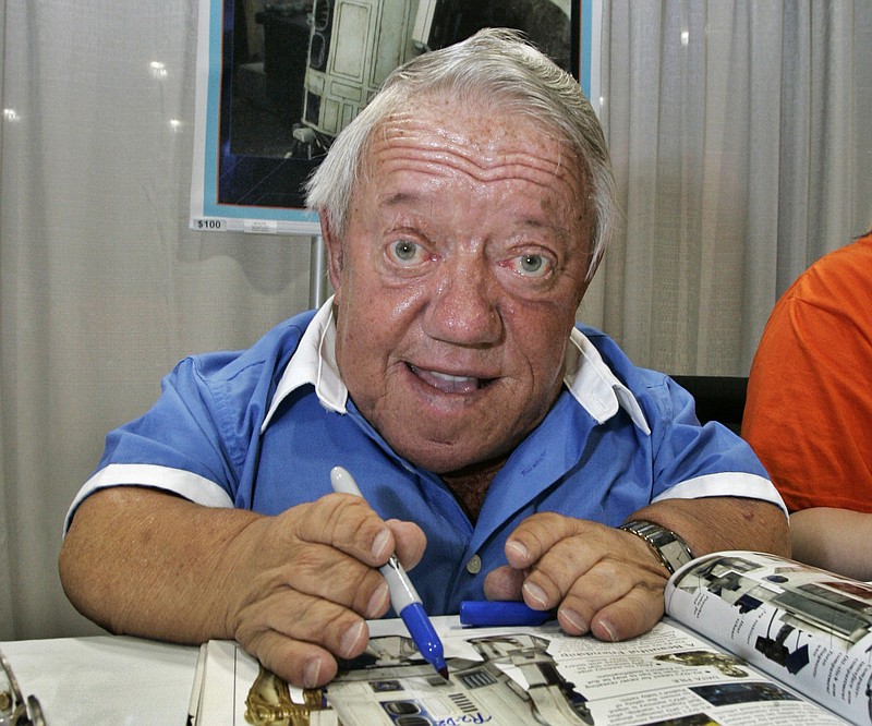 
              CORRECTS BAKER'S AGE. FILE- In this Saturday, May 26, 2007 file photo, actor Kenny Baker, who portrayed the R2-D2 in the first Star Wars movie, signs autographs at Star Wars Celebration IV, billed as the world's biggest Star Wars party, marking the 30th anniversary of the release of the first film in the Star Wars saga, at the Los Angeles Convention Center. Baker, 81, has died Saturday, Aug. 13, 2016. His niece, Abigail Shield, said he was found dead by a nephew on Saturday at his home in northwest England after a long illness. (AP Photo/Reed Saxon, File)
            