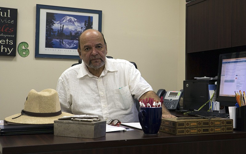 
              Rev. and Puerto Rican community organization director Roberto Luis Lugo poses at his desk on Friday, Aug. 12, 2016, in Philadelphia. With Puerto Rico's economy in shambles, many are fleeing to the mainland U.S., potentially shifting demographics in some of the country's most critical battleground states. (AP Photo/Dake Kang)
            