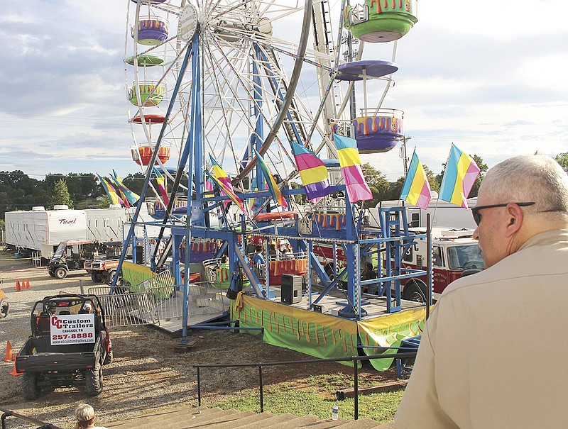 Law enforcement cordon off the area surrounding the Ferris wheel Monday, Aug. 8, 2016, after three people fell from the ride during a county fair in Greenville, Tenn. Baileyton police Officer Kenneth Bitner is visible at right. (O.J. Early/The Greeneville Sun via AP)