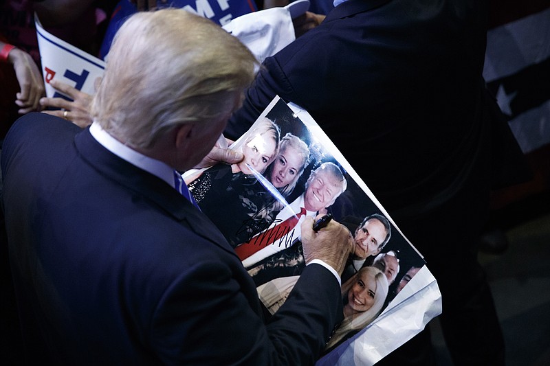 Republican presidential candidate Donald Trump signs autographs during a campaign rally at the BB&T Center, Wednesday, Aug. 10, 2016, in Sunrise, Fla. (AP Photo/Evan Vucci)