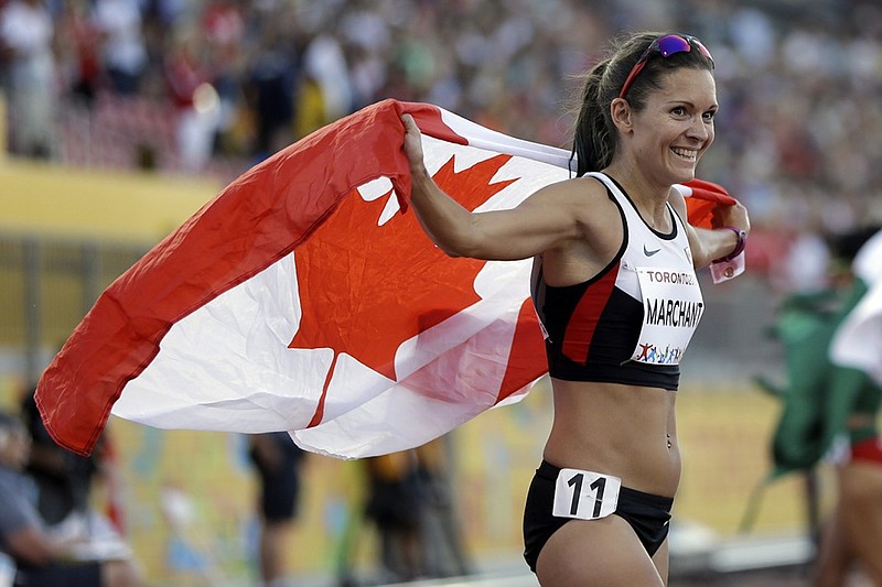 Lanni Marchant celebrates after winning the bronze medal in the women's 10,000-meter run while representing Canada at the Pan Am Games in Toronto in July 2015. Marchant, a Chattanooga attorney and former UTC distance runner, competed in the same event as well as the marathon at the Olympics in Rio de Janeiro.