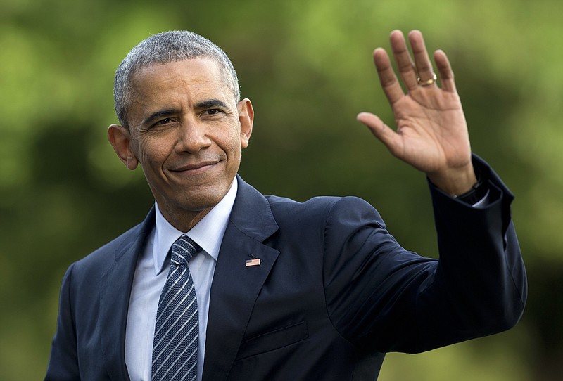 
              FILE - In this July 5, 2016 photo, President Barack Obama waves as he walks across the South Lawn of the White House, in Washington, as he returns from Charlotte, N.C. where he participated in a campaign event with Democratic presidential candidate Hillary Clinton. Obama is interrupting his summer vacation to do some campaigning for Hillary Clinton, the Democratic presidential nominee. Obama is slated to headline a Democratic Party reception Monday, Aug. 15, 2016, on Martha's Vineyard, the tony Massachusetts island where he's been vacationing with his family. (AP Photo/Carolyn Kaster, File)
            