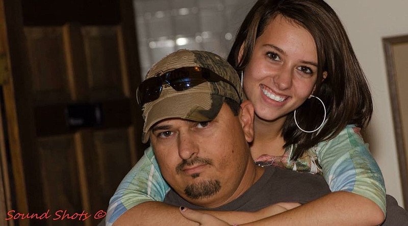 Chickamauga's Anna Haney hugs her father Rusty Haney prior to being diagnosed with cancer.