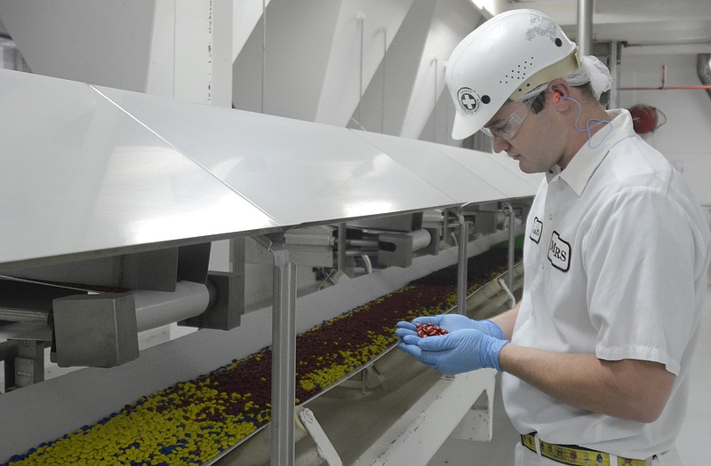 Dustin Cain checks M&M's at the Mars Inc. plant in Cleveland.