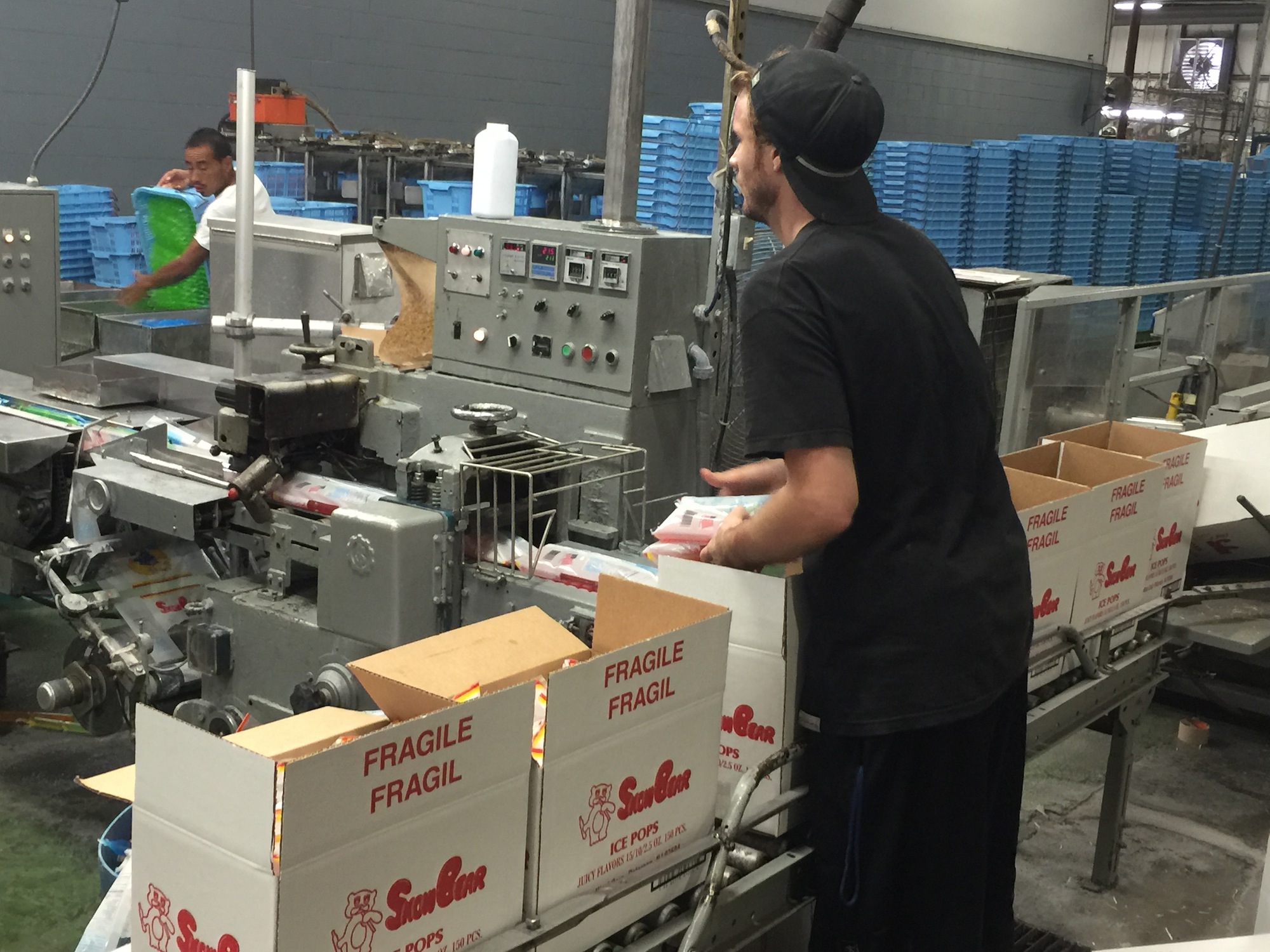 Ryan Haertl, a packer at Fun Treats, packs Snow Bear ice pops at the company's Cleveland, Tenn., plant.
