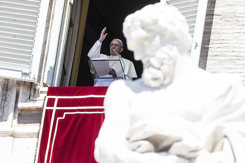 
              Pope Francis waves to faithful from the window of his studio overlooking St. Peter's Square, at the Vatican Monday, Aug. 15, 2016.  Pope Francis is urging people to think about the plight of women who are “slaves of the arrogance of the powerful” as well as children forced to do “inhumane” work. In remarks to tourists and pilgrims in St. Peter’s Square Monday, Francis decried that some women “are obliged to surrender in body and spirit to the covetousness of men.” (Angelo Carconi/ANSA via AP)
            