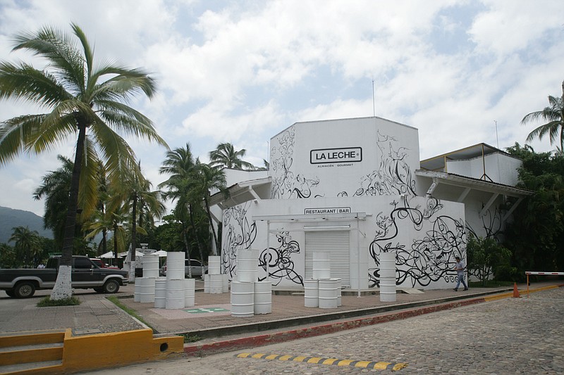
              The entrance of the restaurant "La Leche" stands closed after armed men abducted as many as 16 people who were dining in the upscale restaurant in Puerto Vallarta, Mexico, Monday, Aug. 15, 2016. Jalisco state prosecutor Eduardo Almaguer said in a news conference that preliminary results of the investigation indicate that all involved, kidnappers and kidnapped, were members of criminal organizations. (AP Photo/David Diaz)
            